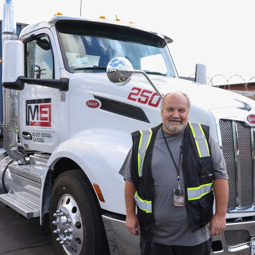 Employee Standing In Front Of Truck